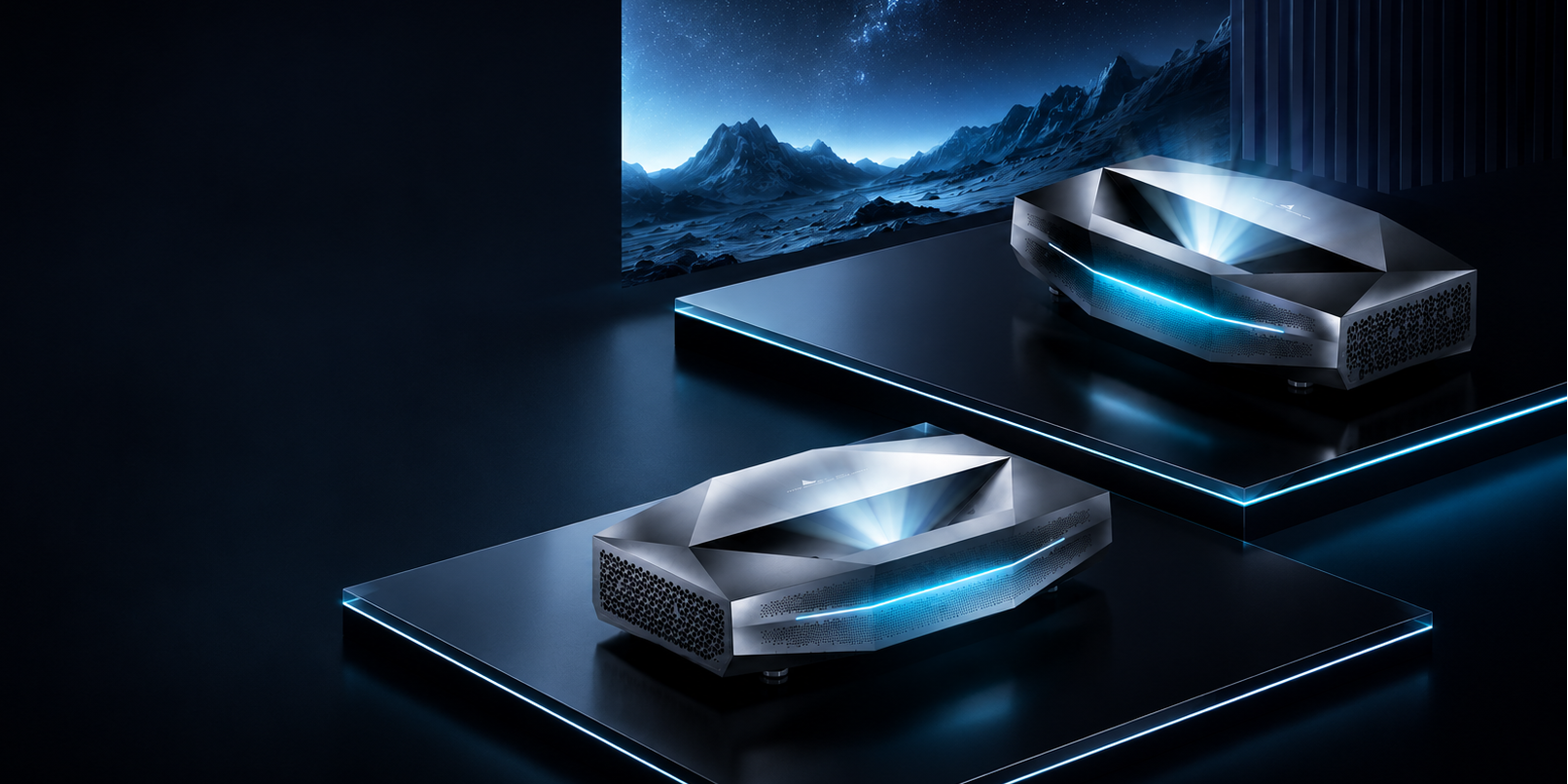 Two sleek, futuristic gaming PCs with glowing blue LED accents are displayed on dark pedestals in a dark, atmospheric studio setting. A large screen in the background shows a dramatic blue mountain landscape.