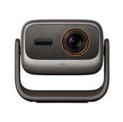 A JMGO brand digital projector shown from the front on a clean white background. The device features a dark gray and black textured faceplate with a prominent circular lens surrounded by a metallic gold ring, supported by a dark gray U-shaped stand.